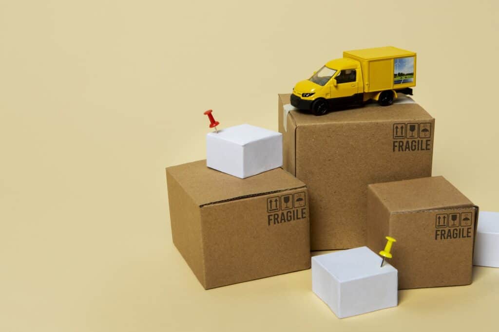 Miniature cardboard and moving van in the concept of 'What Are Man and Van Services'.