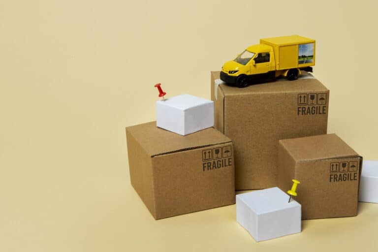 Miniature cardboard and moving van in the concept of 'What Are Man and Van Services'.