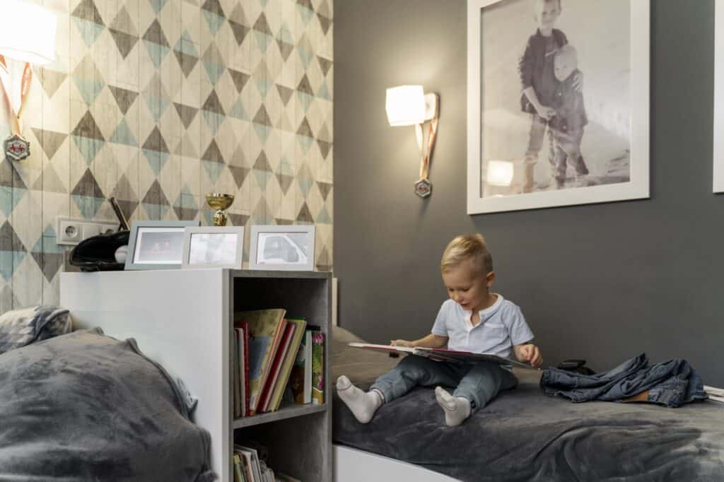 A kid reading a book in his room post-move