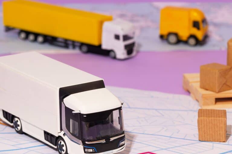 Miniature boxes and home removals vehicles of different sizes in the concept of 'Differences Between Man and Van Services and Traditional Removals'.
