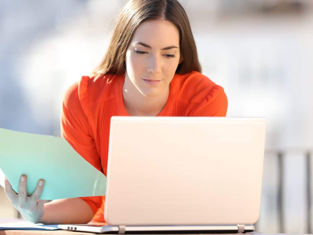 A woman is in front of her laptop, comparing man and van costs to move to Wood Green